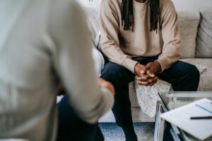 A serene conversation between two people in a therapy session for Trauma healing. Zip Codes: Austin area 78746, 78730, 78733, 78739, 78732, 78701, 78703. Round Rock area 78681, 78665, 78641, 78717, 78613.