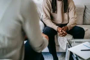A serene conversation between two people in a therapy session for Trauma healing. Zip Codes: Austin area 78746, 78730, 78733, 78739, 78732, 78701, 78703. Round Rock area 78681, 78665, 78641, 78717, 78613.