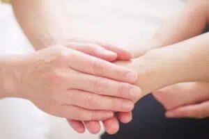 A close-up of two hands clasped together, symbolizing support and healing from EMDR trauma. Zip Codes: Austin area 78746, 78730, 78733, 78739, 78732, 78701, 78703. Round Rock area 78681, 78665, 78641, 78717, 78613.